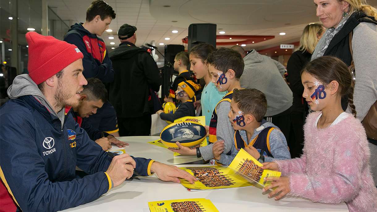 AFC footballers signing autographs for kids